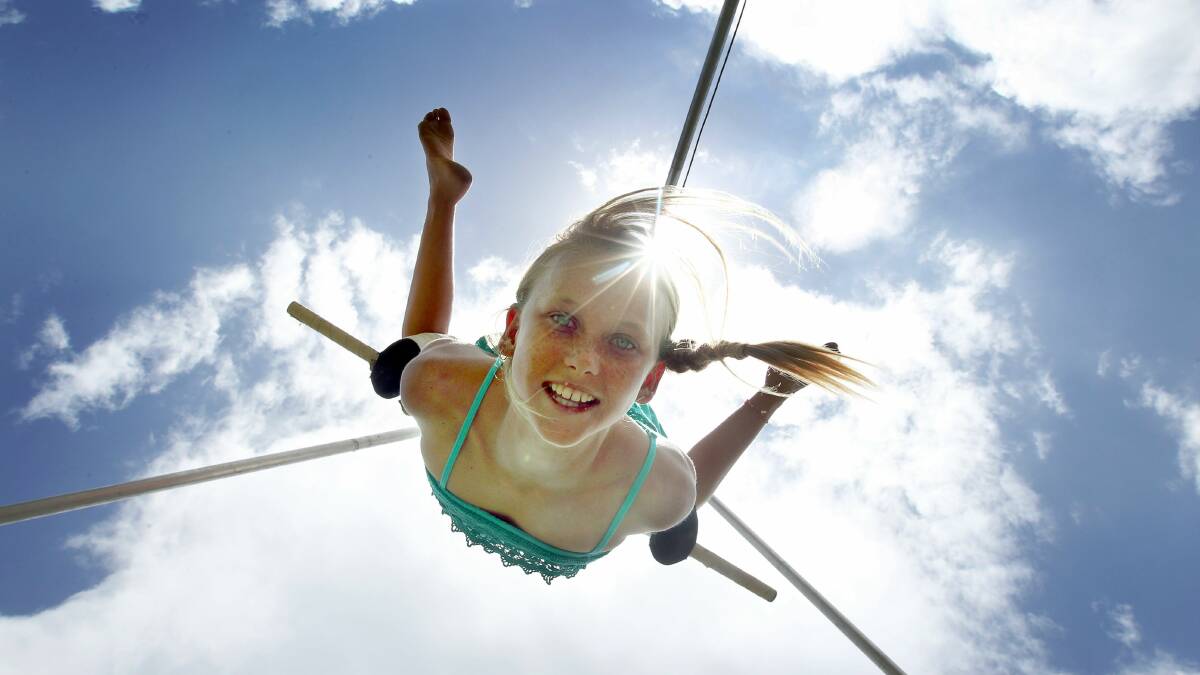 Jaime Chapman flies high on the trapeze at the Kiama International Seaside Arts Festival. Picture: SYLVIA LIBER