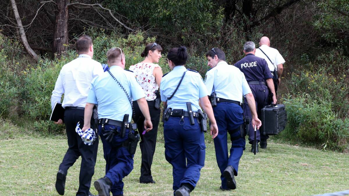 Police in Farmborough Heights yesterday after children discovered a man's body. Picture: ADAM McLEAN