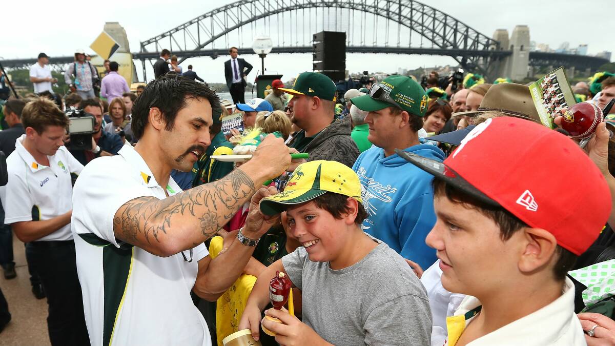 Mitch Johnson signs autographs for fans at the Sydney Harbour Bridge yesterday during the Ashes celebrations. Picture: GETTY IMAGES