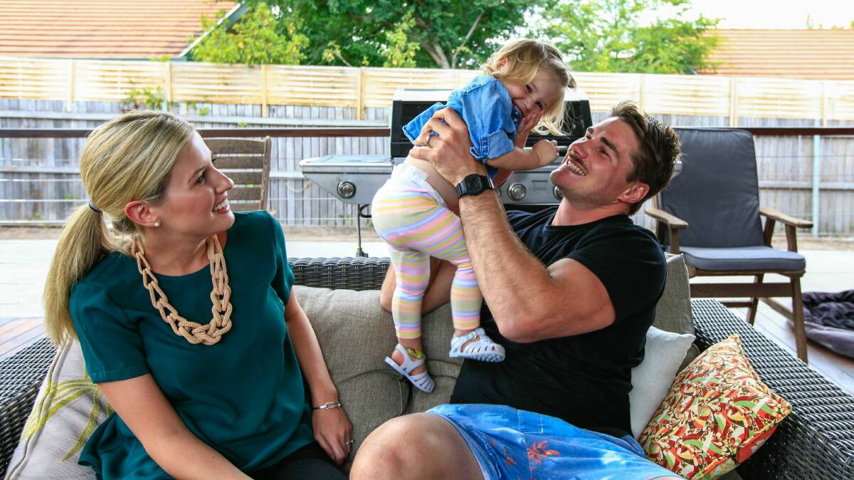 Ben Mowen at home yesterday with his wife Lauren and 18-month-old daughter Eleanor. Picture: KATHERINE GRIFFITHS