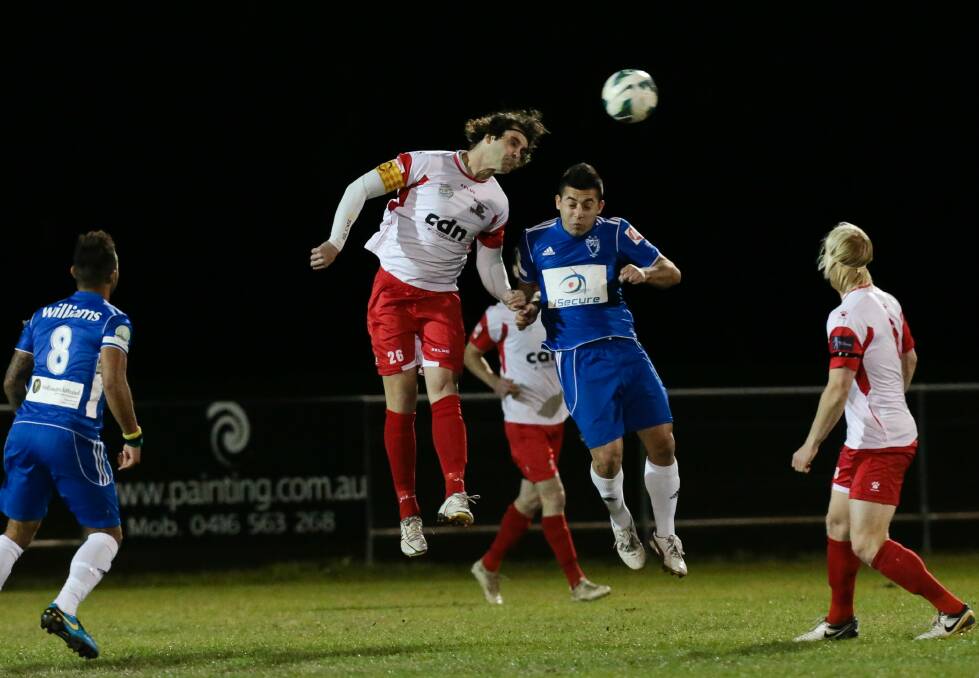 Jacob Timpano, centre left, climbs for a header in South Coast Wolves’ clash with Sydney Olympic in Berkeley. Picture: ADAM McLEAN