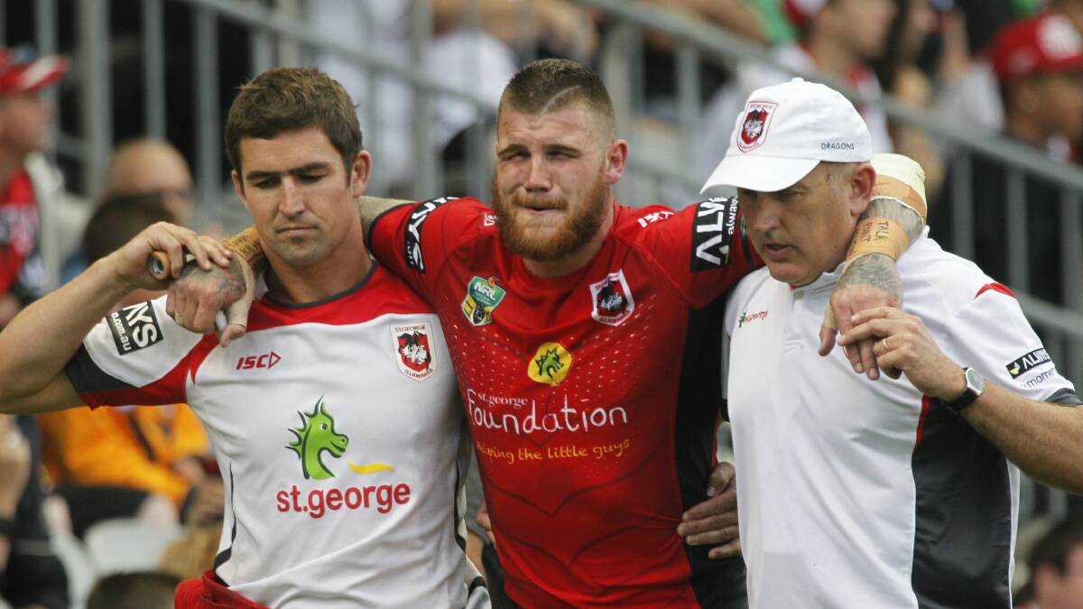 Dragons fullback Josh Dugan is helped from the field after being injured in Saturday night's Charity Shield match against Souths. Picture: CHRISTOPHER CHAN