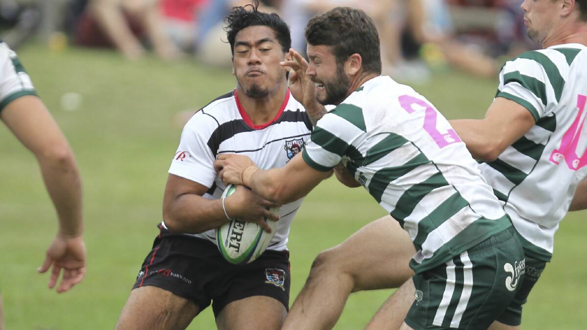 A West Harbour player is confronted by Warringah opponents in this all-Sydney clash in Kiama. Picture: DAVID HALL