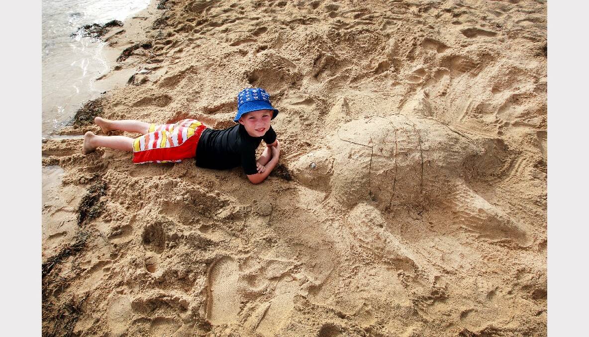 Anthony Sowerby, 7, of Warilla with his turtle sand sculpture at Reddall Reserve. Pictures: SYLVIA LIBER