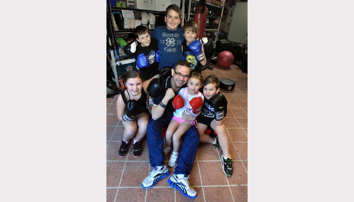 Brad Gallagher shares some boxing tips with nieces and nephews (front, from left) Ruby Churchin, Molly Lazicic, Max Lazicic, and (back) Hugh Edwards, Noah Lazicic and Ethan Robson. 