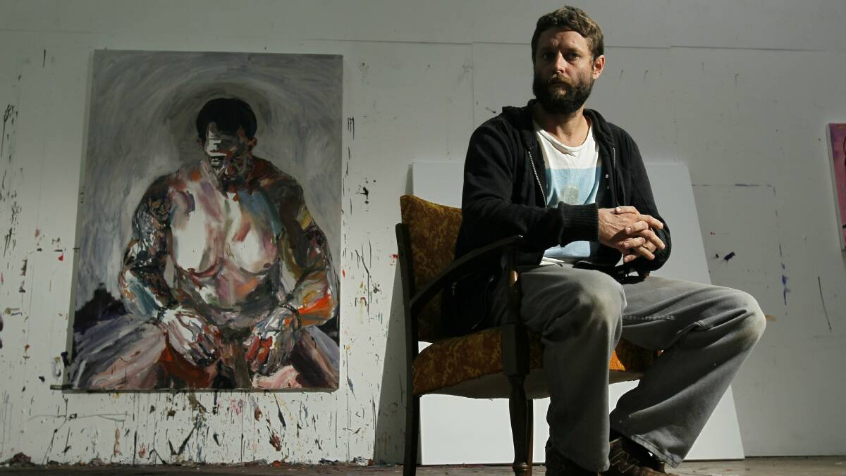Artist Ben Quilty in his Robertson studio with one of his paintings. Picture: DAVE TEASE