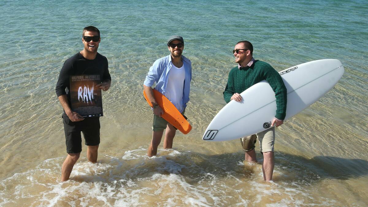 Pro surfer Dean Bowen (left) with producers Cohan Banfield and Mark Brightwell on Wollongong Beach. Picture: KIRK GILMOUR