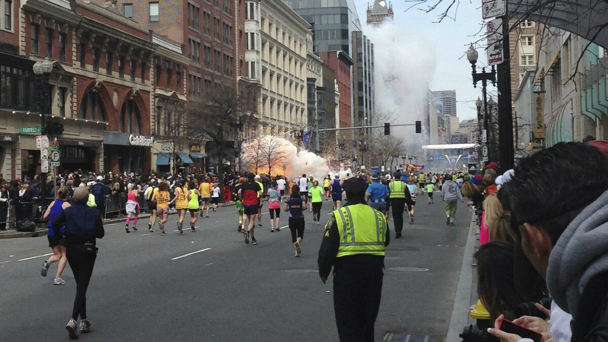 Competitors at the scene of an explosion in Bolyston Street, Boston. Picture: REUTERS
