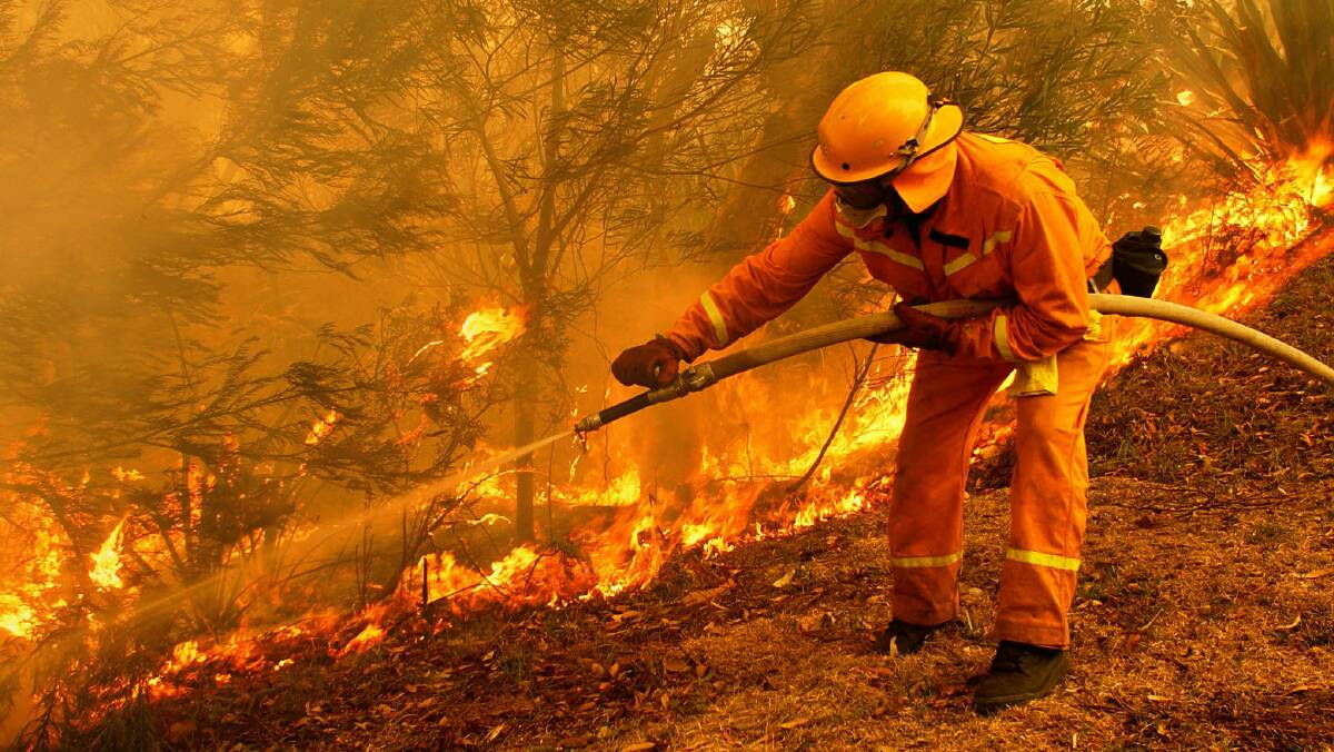A firefighter battles a blaze in Heathcote on December 27, 2001. Picture: REUTERS