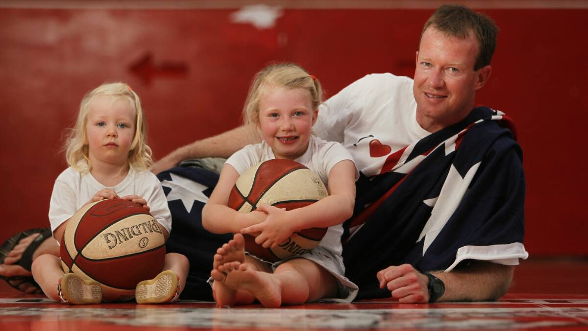 Sarah, 2, and Hannah, 5, with their dad Australia Day ambassador Mat Campbell. Picture: DAVE TEASE