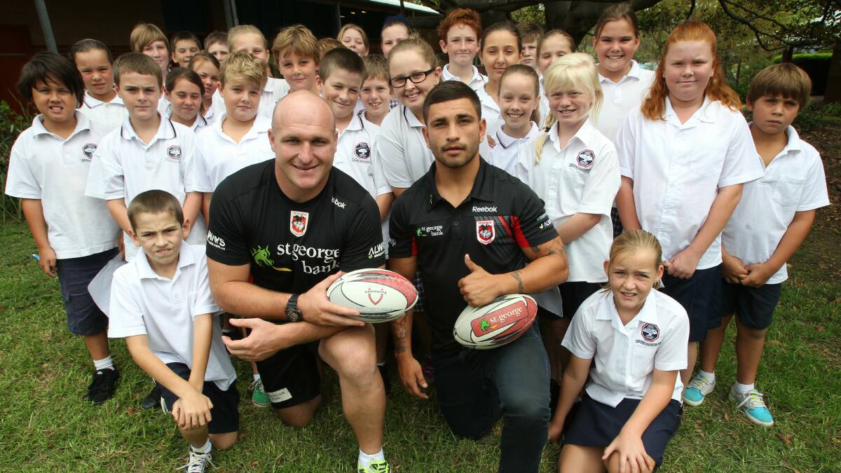  Dragons players Michael Weyman and Evander Cummins with some of the kids at Mount Terry Public School.Picture: KEN ROBERTSON