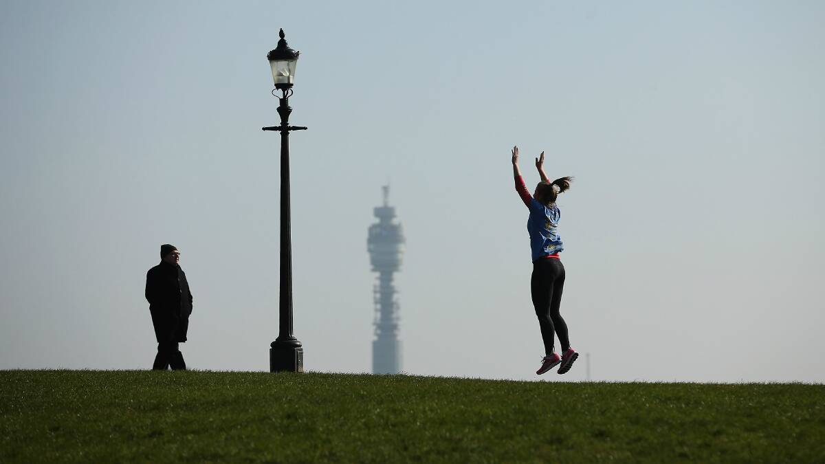A woman exercises during an unseasonably warm day in London. Picture: GETTY IMAGES