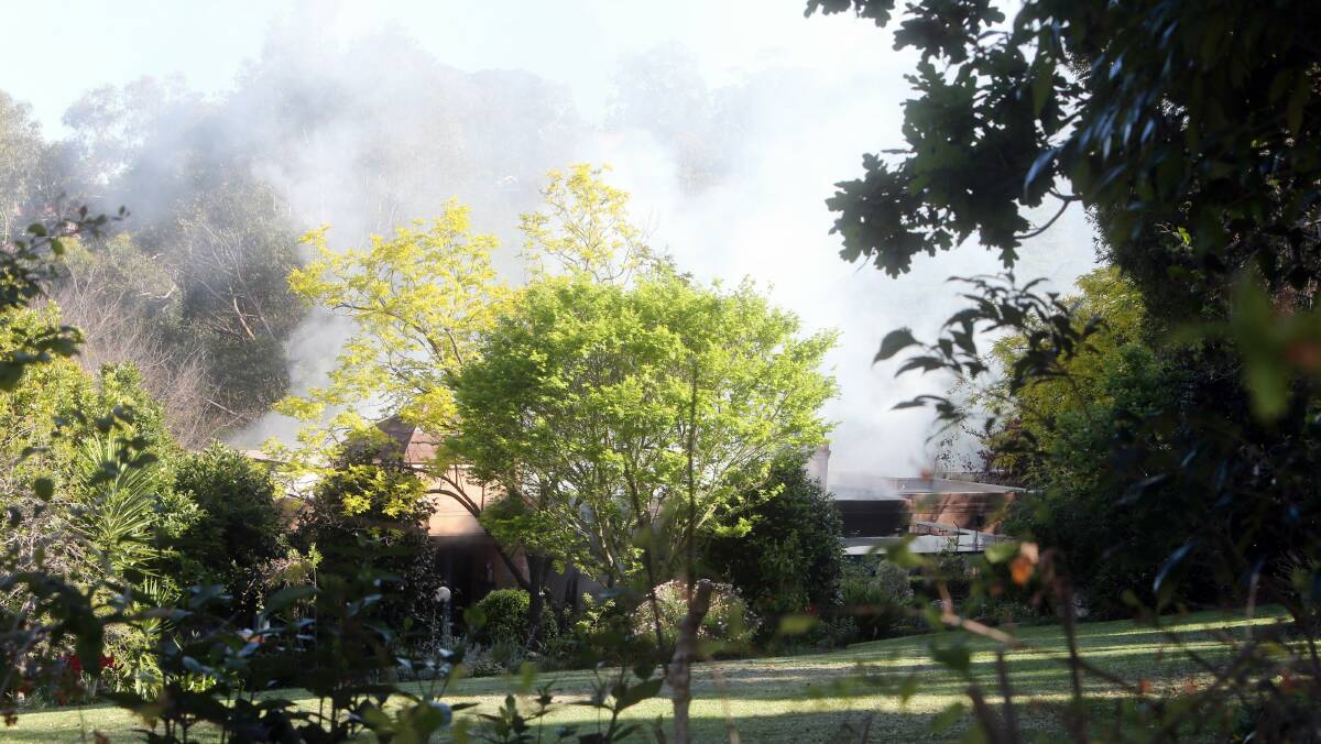 The Mount Kembla home on fire. Picture: ROBERT PEET