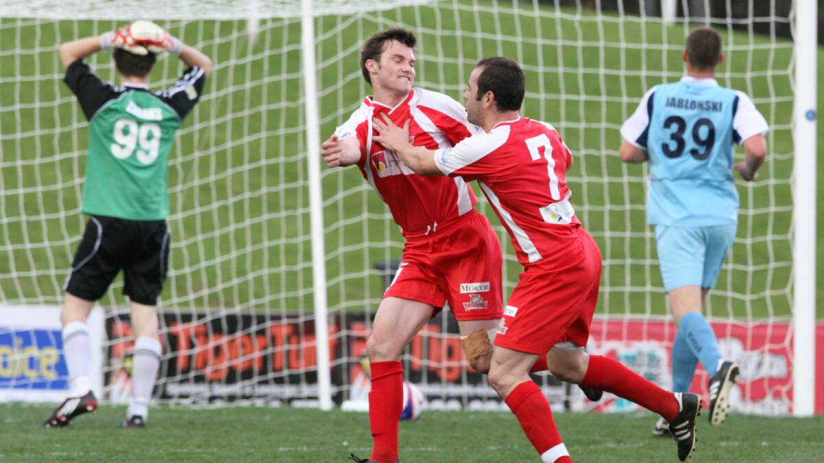  Chris Price, centre left, celebrates scoring for Wollongong FC in the 2008 grand final.