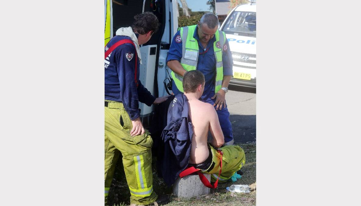 A firefighter is treated for thermal burns from the blaze. Picture: ROBERT PEET