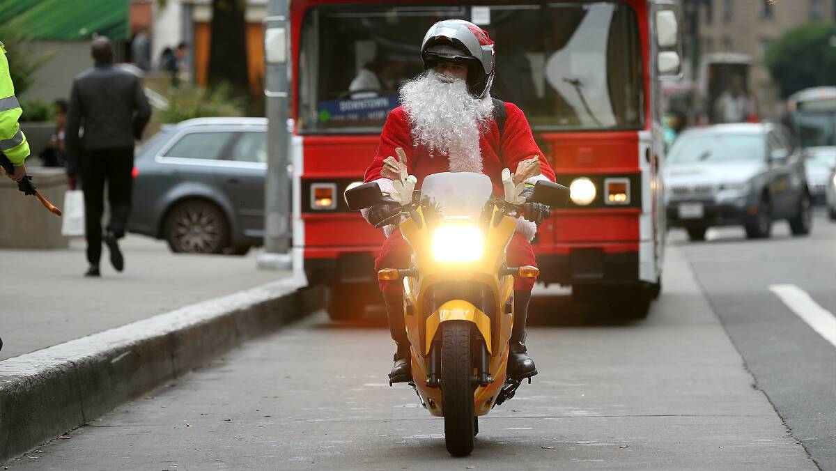 A man dressed as Santa rides a scooter in San Francisco, California. Picture: REUTERS