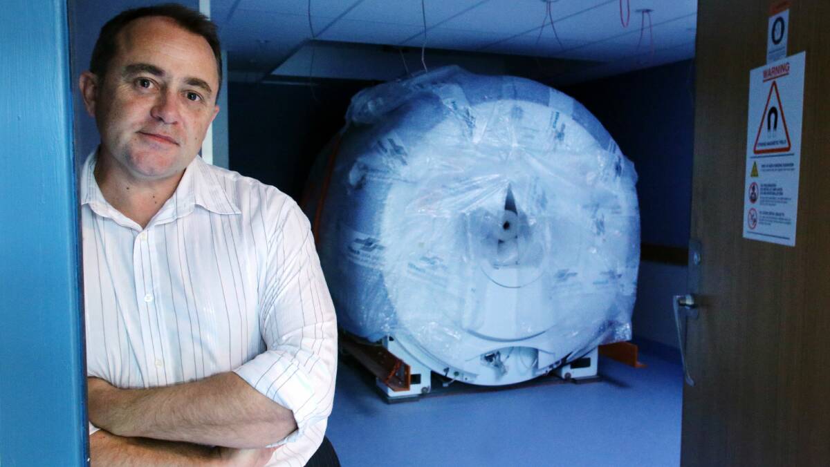 Michael Grey of South Coast X-Ray with the MRI scanner. Picture: ADAM McLEAN