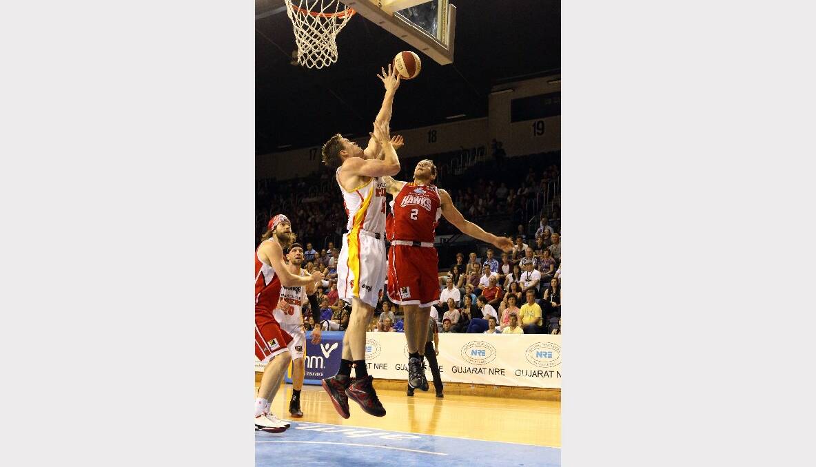 Wollongong Hawks guard Tyson Demos, right, in action against the Melbourne Tigers. Picture: ROBERT PEET