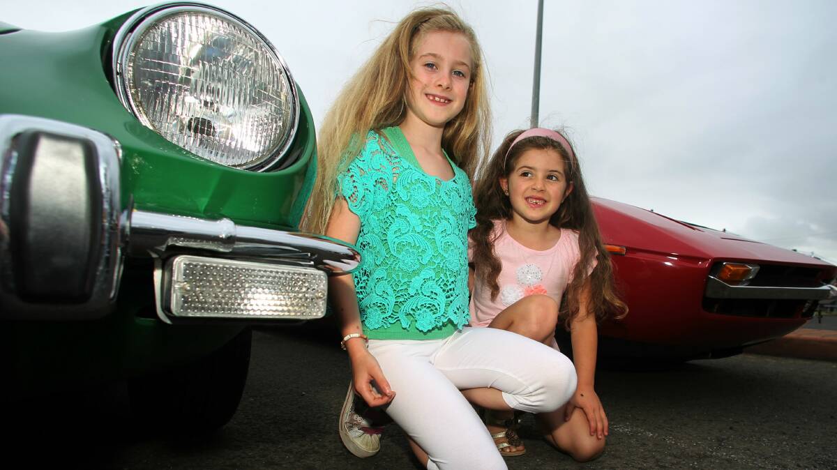Sophia and Lily Paiola from Figtree admire the vintage cars. 