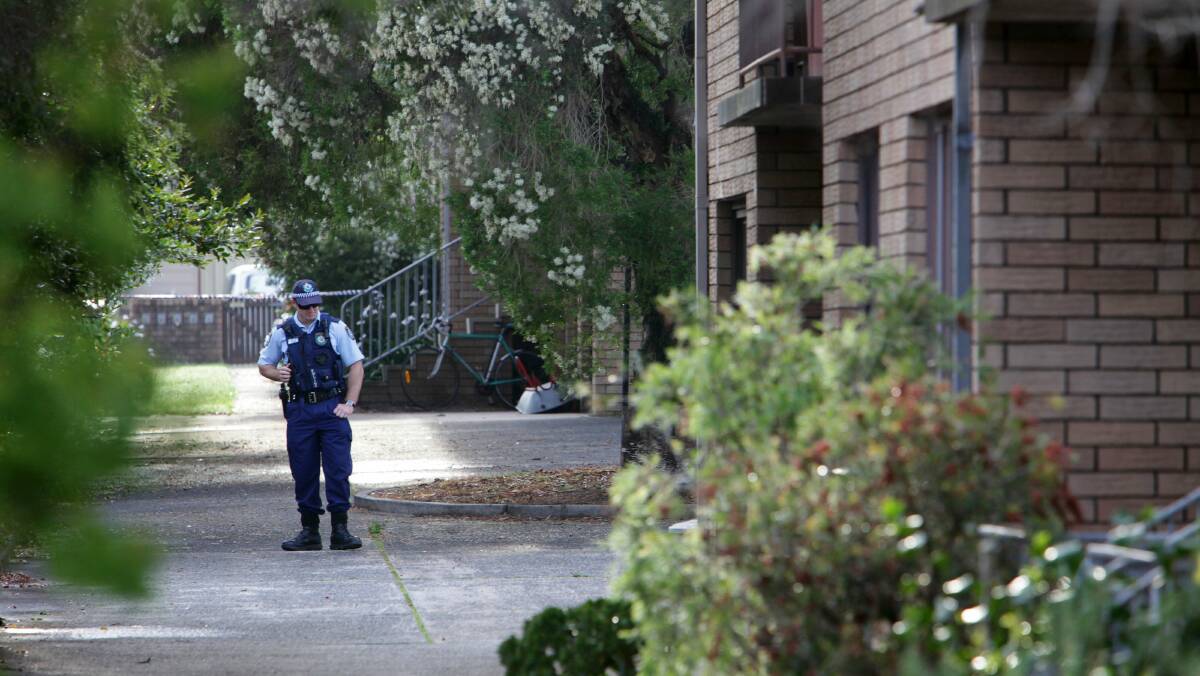 Police attend the scene at an apartment complex in Bulli. 