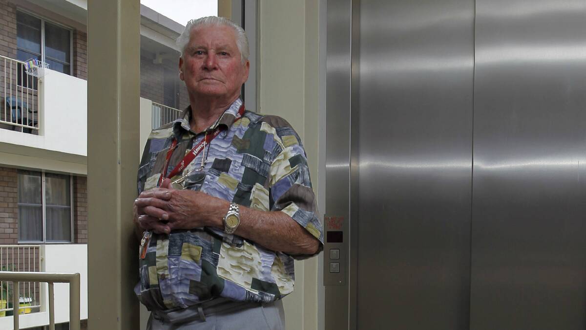 Resident Ron Pilcher outside the stalled lift in a  Housing NSW unit block. Picture: ANDY ZAKELI