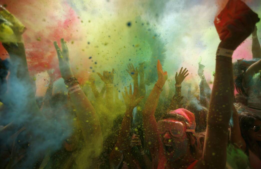 Revellers are covered in coloured cornflour during a festival in Cape Town. Picture: REUTERS