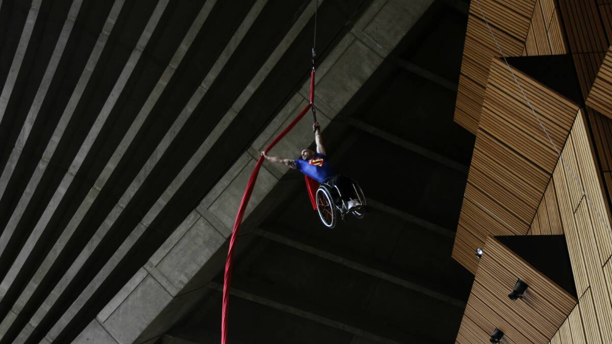 Paul Nunnari climbs a silk rope before performing an aerial display above Crown Street Mall. Picture: SYLVIA LIBER