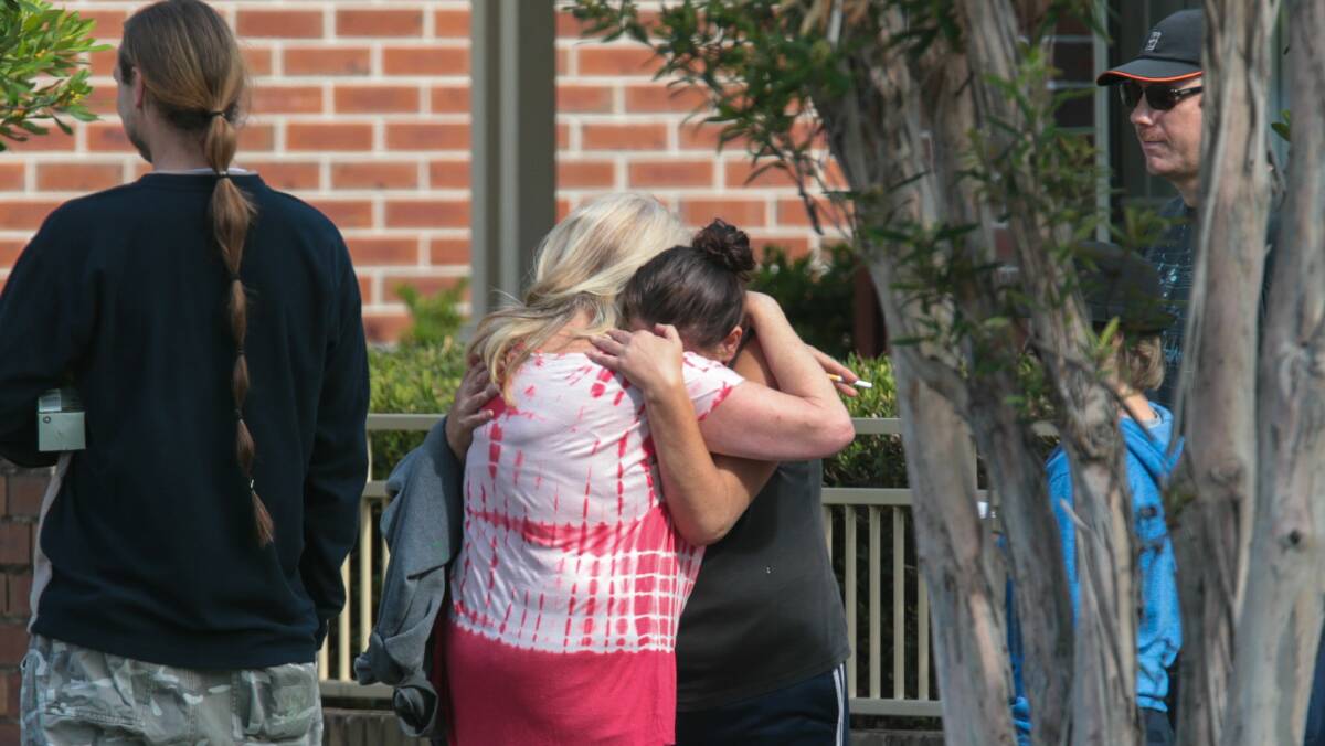 A woman is comforted at the scene of Thursday night’s double shooting. Picture: ADAM McLEAN