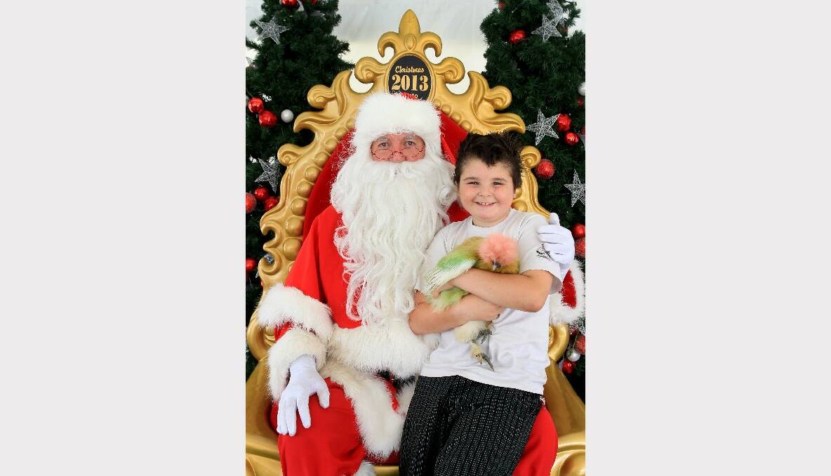 Bailey Tye and Zoe tell Dapto Mall's Santa what they want for Christmas. Picture: ORLANDO CHIODO