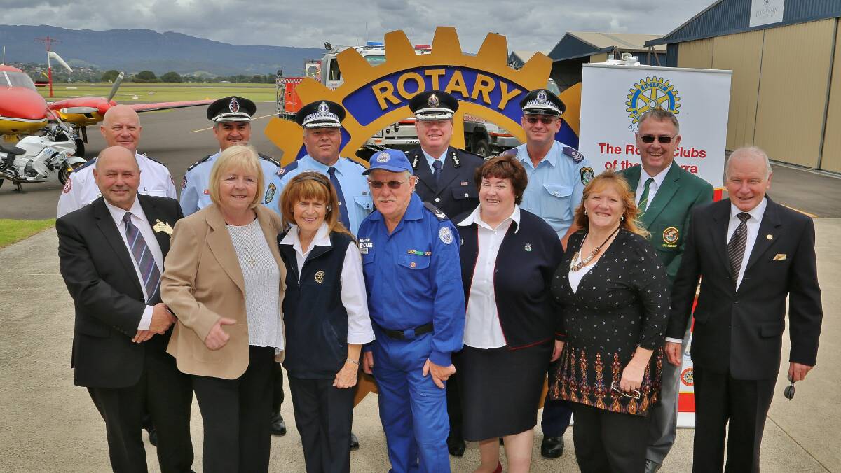 Emergency service personnel, Rotarians and political and civic leaders at Illawarra Regional Airport. Picture: GREG ELLIS
