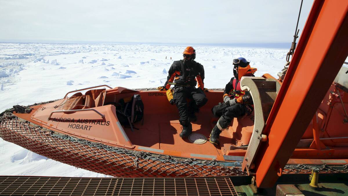 Rescuers aboard the Australian icebreaker Aurora Australis are lowered on a rescue boat to an ice floe next to the ship where a Chinese helicopter will land with passengers from the Akademik Shokalskiy. Picture: Nicky Phillips