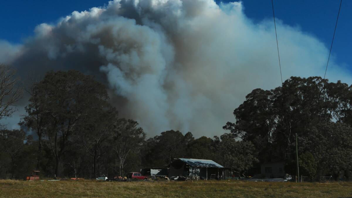 A home on Wilton Road with a large plume of smoke coming from the fire zone off Picton Road. Picture: ADAM McLEAN