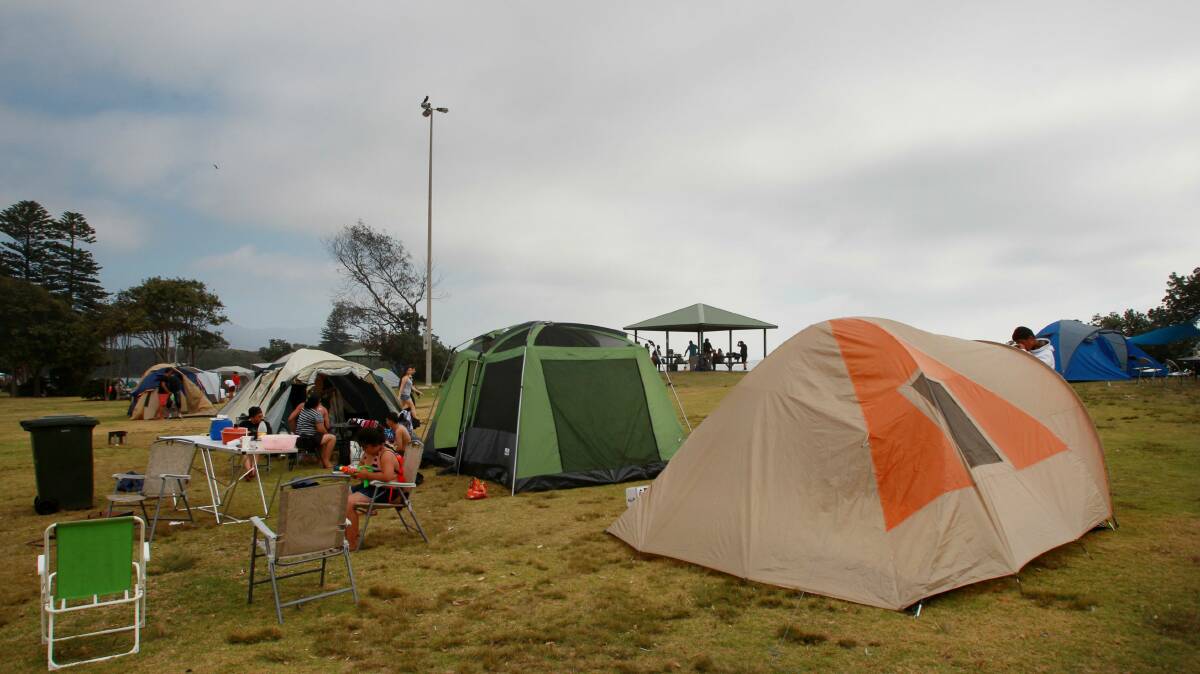 Stuart Park’s tent city was a quiet place to relax for many campers following the changeover to 2013. Pictures: KEN ROBERTSON