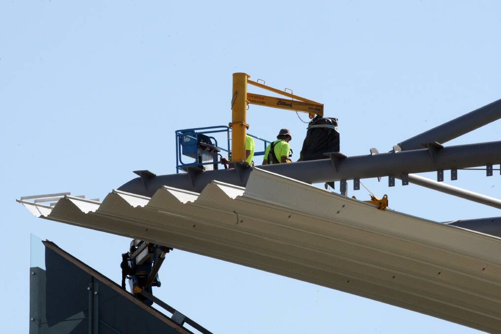 The first roof panels go back on the new grandstand at WIN Stadium in April. Picture: ROBERT PEET