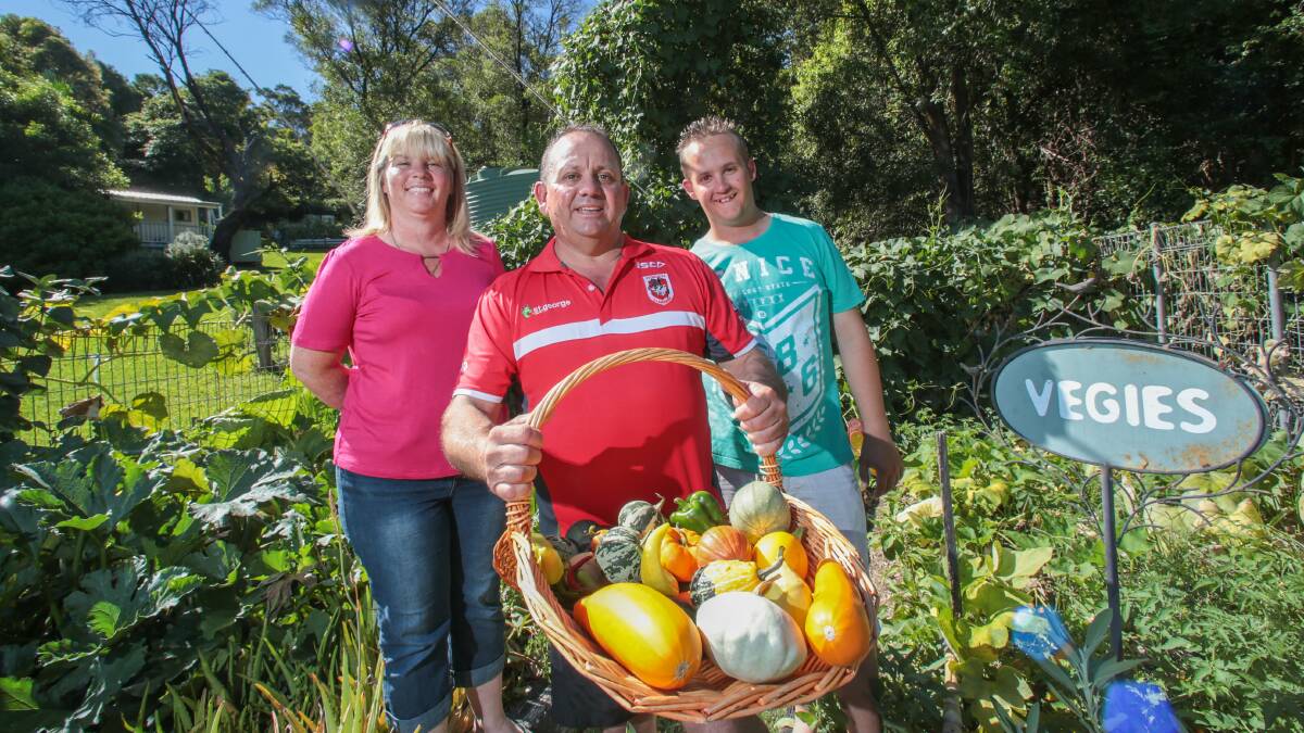 Sonya, Barry and Josh Pawelek proudly display a basket of vegies from their garden. Picture: ADAM McLEAN