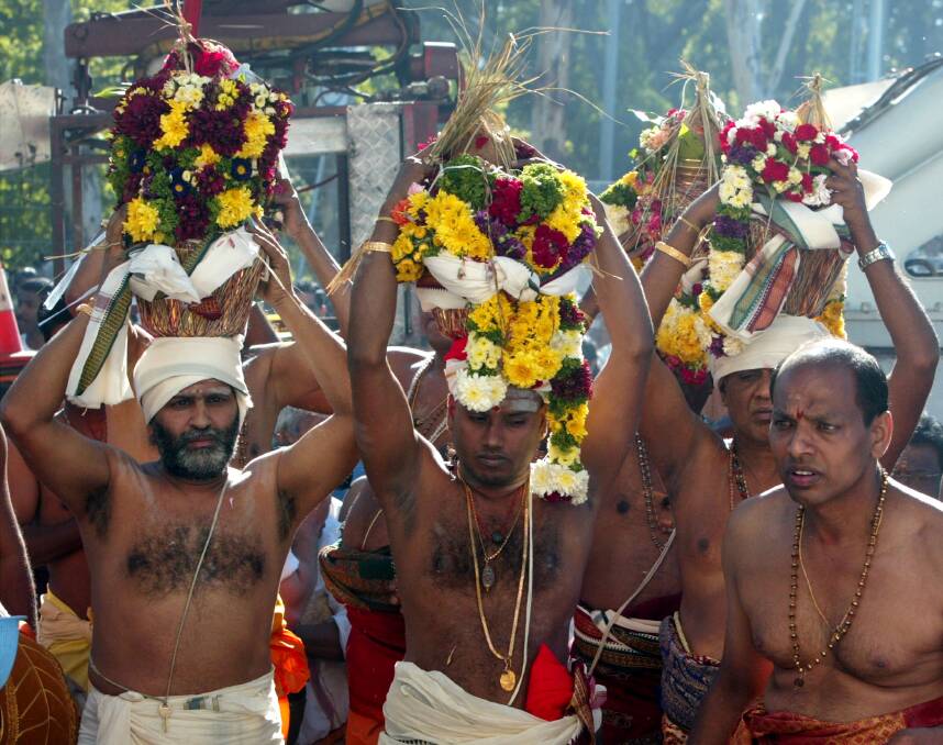 Hindu priests carry offerings into the Sri Venkateswara Temple in Helensburgh. The temple, Australia's largest was consecrated.