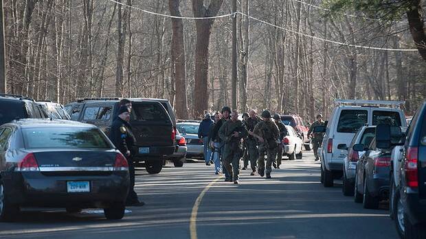 Connecticut State Police walk on Dickson Street from the scene of an elementary school shooting. Picture: DOUGLAS HEALEY