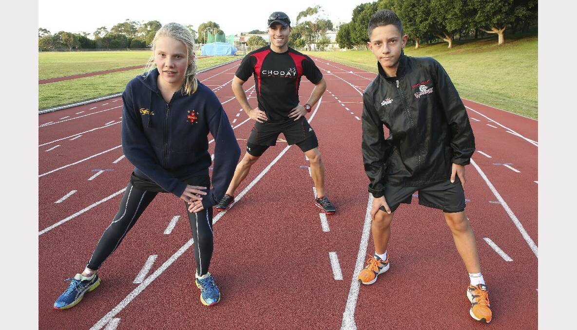 Chloe Johnston, trainer Fabian Iacovelli and Jordan Nikolovski stretch before exercising at Beaton Park. Picture: KEN ROBERTSON