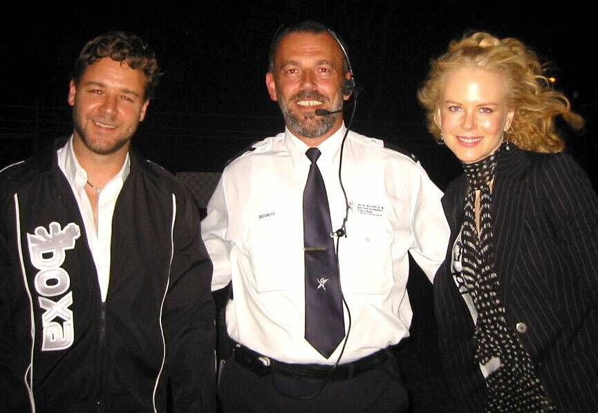 Security manager Norm Rees escorts Russell Crowe and Nicole Kidman at the Mundine-Nishizawa fight at WIN Entertainment Centre.