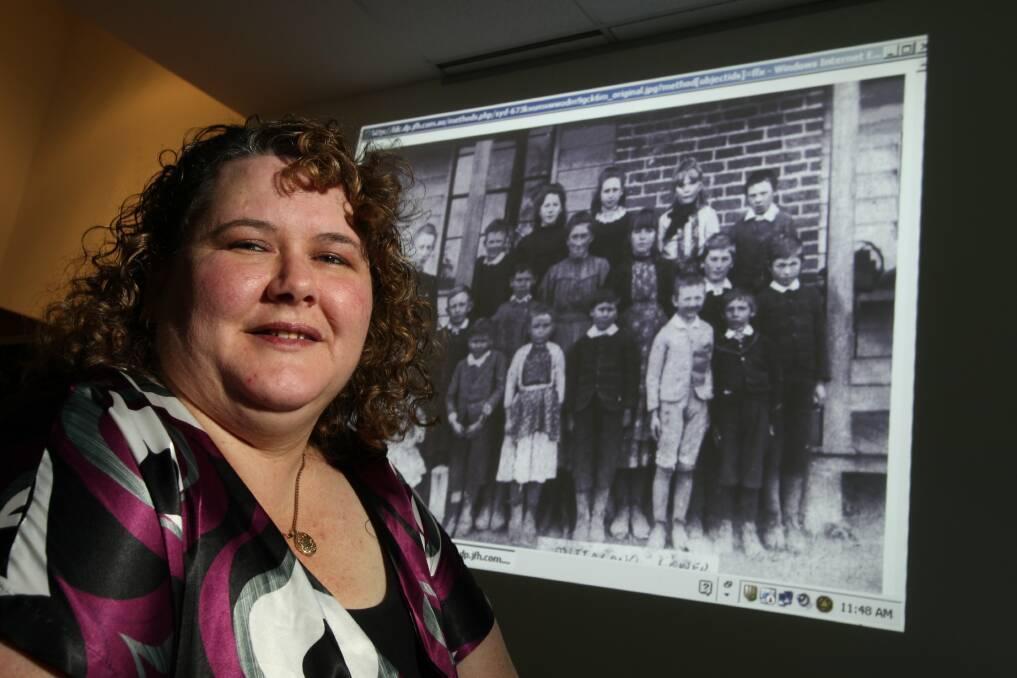 Leeallison Downie with an early photo from the Mittagong Farm Home for Boys. Picture: KEN ROBERTSON