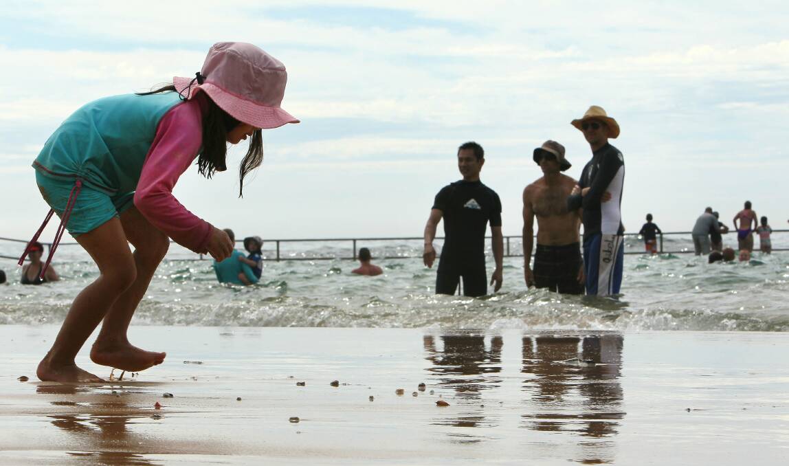The king tide provides entertainment for beachgoers at both ends of the pools at Austinmer Beach. Picture: KIRK GILMOUR