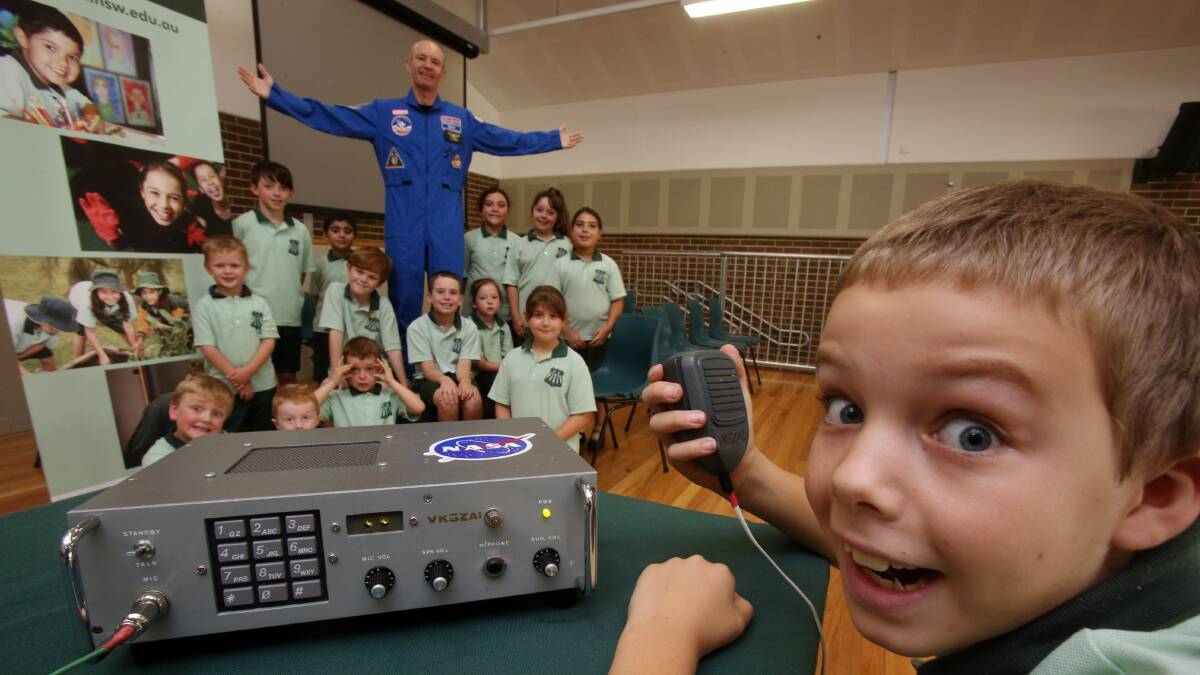 Mount Ousley Public School student Connor Bauer, 10, with fellow students and teacher Neil Bramsen. Pictures: ROBERT PEET
