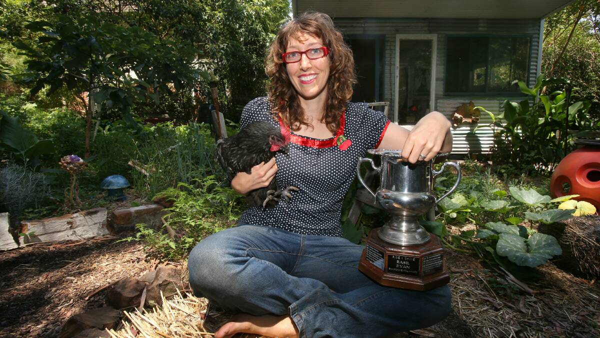 Permablitz the Gong co-founder Jacqui Besgrove in her backyard with the Basil Ryan Award. Picture: ROBERT PEET