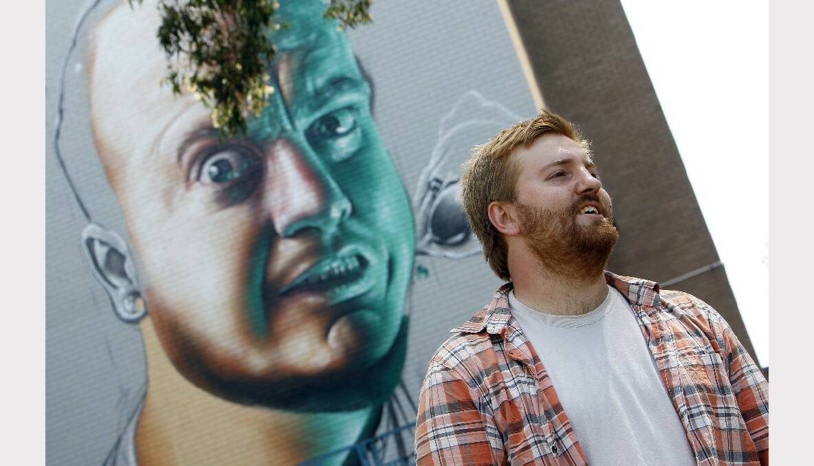 Artist Smug with his wonderwall on the Wollongong Myer building. Picture: ANDY ZAKELI