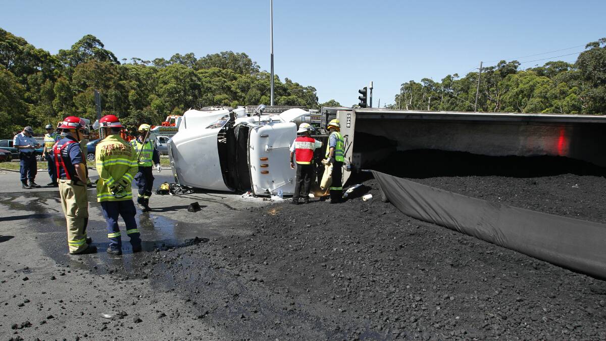 A coal truck lies overturned with its load spilled after a crash on Tuesday. Pictures: CHRISTOPHER CHAN