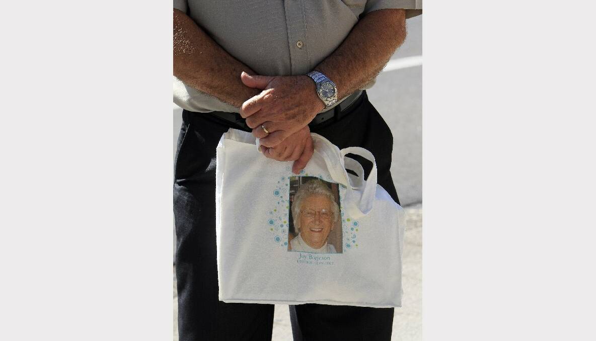 Steven Borjeson holds a bag with his mother’s photo.