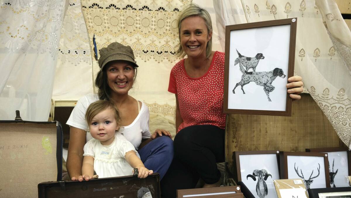 Sara Colville, her daughter Indigo and Dani Green were among those at Thirroul’s first suitcase market. Picture: DAVE TEASE
