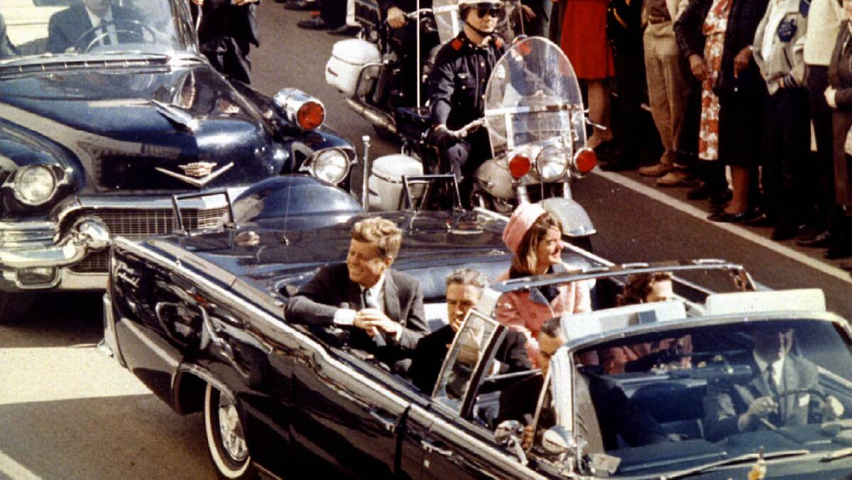 US president John F Kennedy with his wife, Jackie Kennedy, ride through Dallas moments before JFK was assassinated on November 22, 1963 .