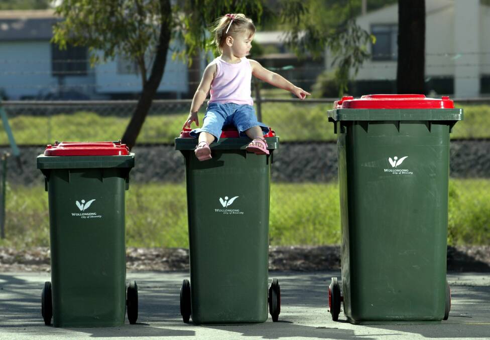 Two-year-old Jayda with the three sizes of bins to choose from.