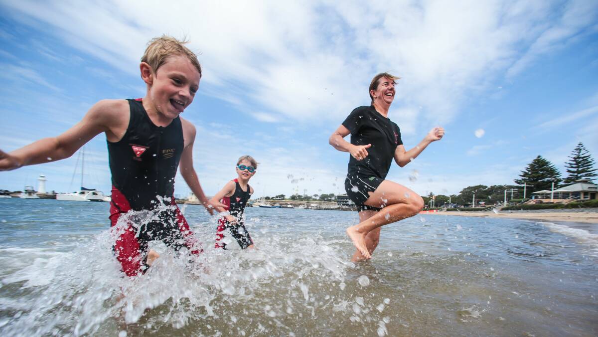 Aquathon competitors Aidan, 7, Regen, 6, and Simone Campbell in Wollongong Harbour. Pictures: ADAM McLEAN